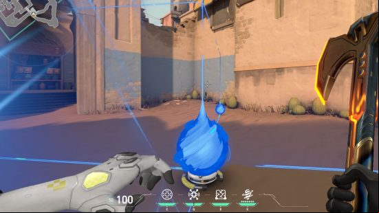 A huge ball of blue energy runs parallel to  with another on a dusty, crumbling desert location