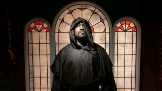 Diablo 4 chocolate shop - a hooded monk stands before a stained-glass window.